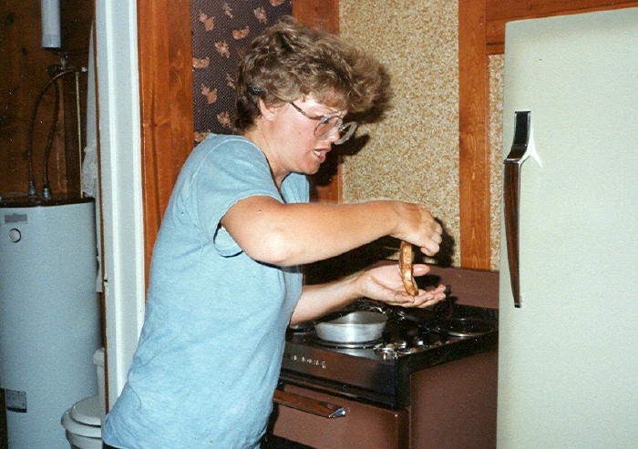 Kathy is trying to give one of us some hot toast right off the grill.