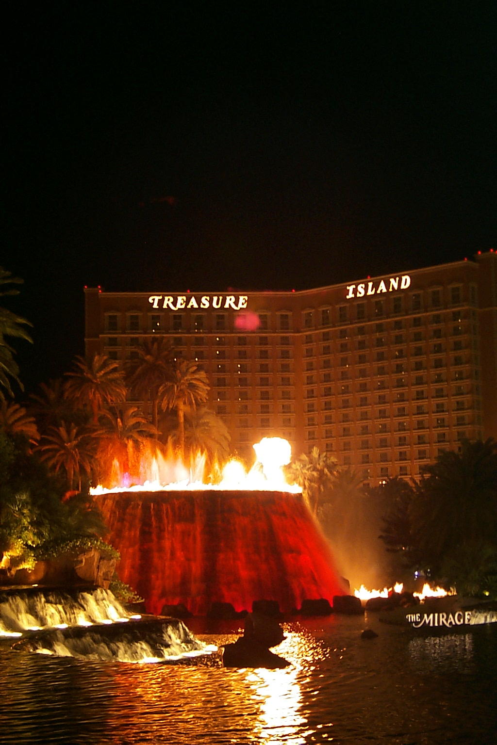 The Volcano eruption at night in front of the Mirage. The Treasure Island Casino is in the background.